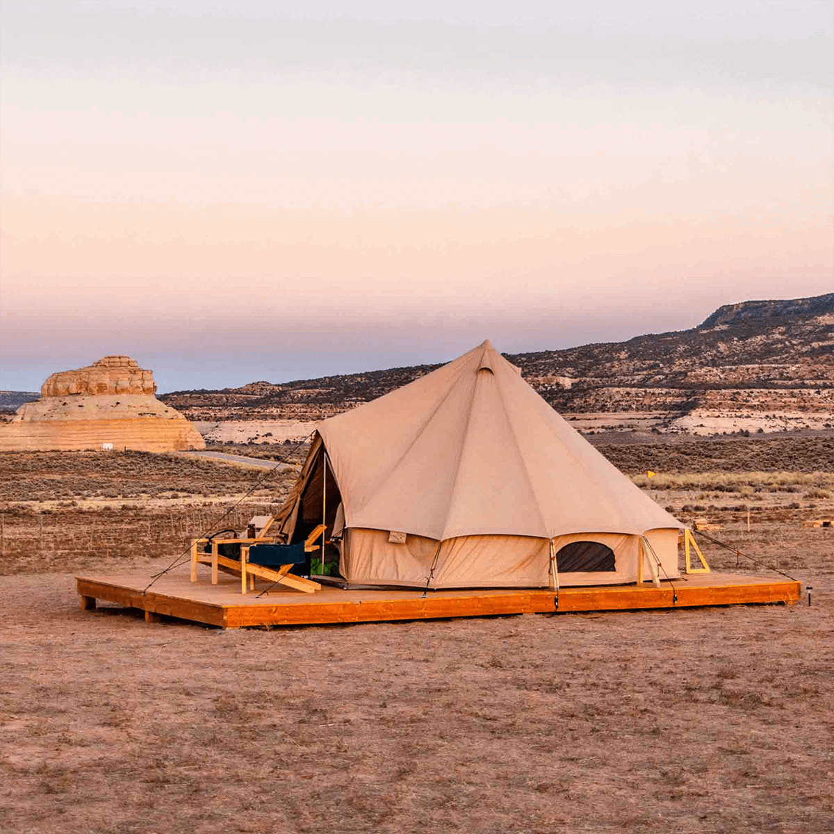 Regatta bell tent sandstone beige side view in sandy area on a platform