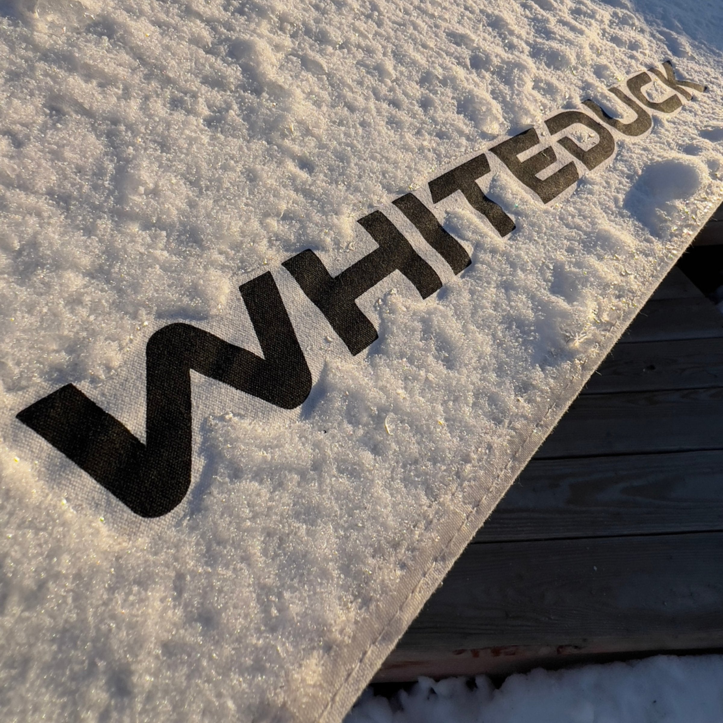 avalon bell tent in the snow with whiteduck logo