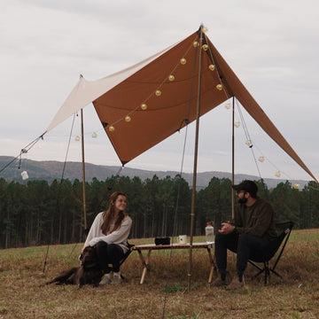 a couple enjoying the outdoors under the sunshade tarp