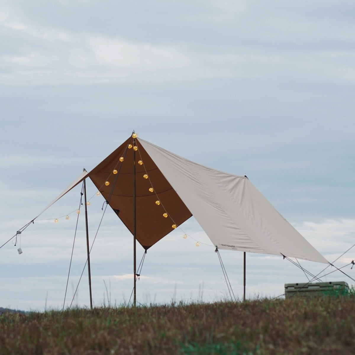sunshade tarp setup outdoors in a grassy field