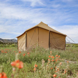 18 altimus bell tent placed outdoors near flowers with a back view