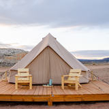 Regatta Bell Tent sandstone beige placed on platform with two chairs 