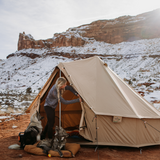 Regatta bell tent sandstone beige in a snowy mountain setting with a girl and her two dogs camping