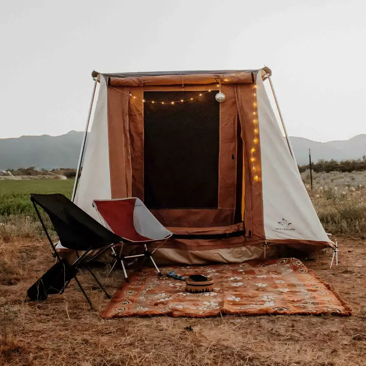 a prota cabin tent with chairs and rugs - cozy camping