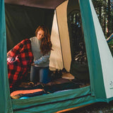 women preparing cabin tent for cozy camping experience