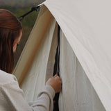 avalon bell tent door fly being opened by a woman