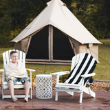 Beige 10' Regatta Bell Tent in the background with a kid wearing a towel sitting on a one out of two chairs in front of it