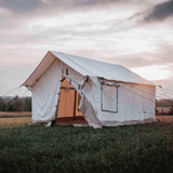 canvas alpha wall tent placed outdoors with door fly open