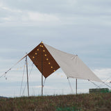 sunshade tarp setup outdoors in a grassy field