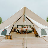 20 avalon bell tent set up for glamping with a bed and furniture inside