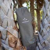 Hoplite Canvas Top Load Bag in olive color hanging on a tree