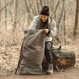 Hoplite Canvas Top Load Bag olive color being used outdoors by a girl